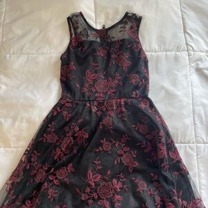Black dress with red floral detailing.